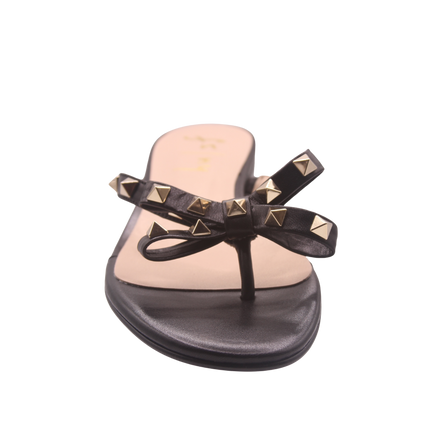black thong sandal with two bow-shaped straps decorated with gold pyramid studs front view 