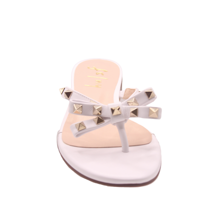 white thong sandal with two bow-shaped straps decorated with gold pyramid studs front view 