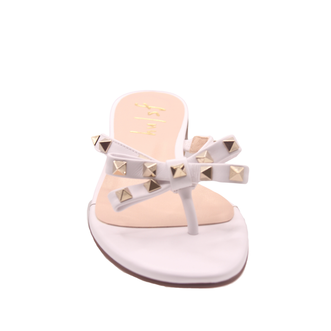 white thong sandal with two bow-shaped straps decorated with gold pyramid studs front view 