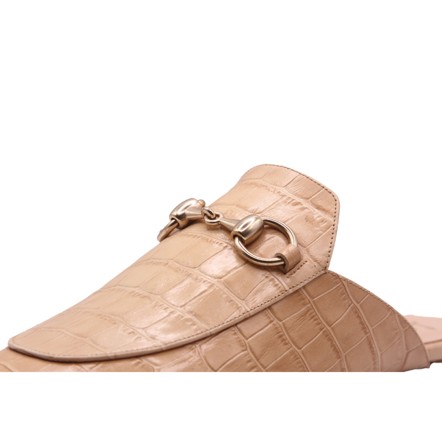 close view of Taupe crocodile-embossed leather mule with a pointed toe, low heel, and a gold buckle detail on the top. 