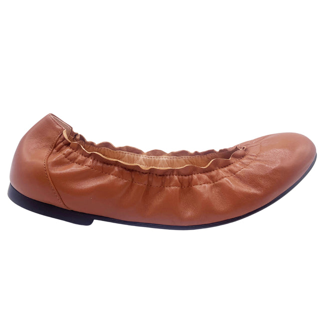 cognac leather ballet flat with a rounded toe and elasticated topline. side view