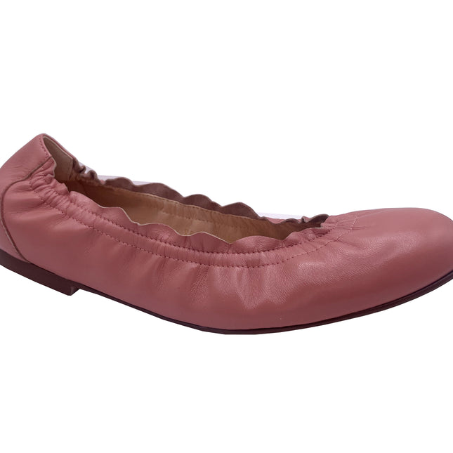A salmon leather ballet flat with a scalloped edge and comfortable rubber sole. angle view 