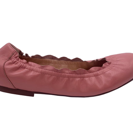 A salmon leather ballet flat with a scalloped edge and comfortable rubber sole.