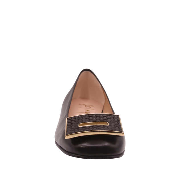 Black leather flat with a square toe, a small heel for slight lift, and a textured black buckle with gold detailing on the toe box front view 