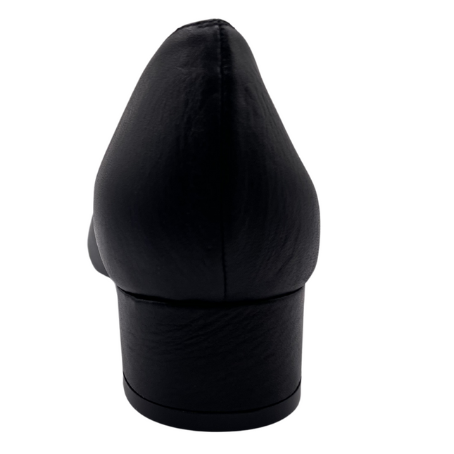 Black leather pump with a rounded toe, block heel, and a silver buckle wrapped in black detailing on the toe box back view 