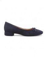 Navy blue flat shoe with a bow on a white background