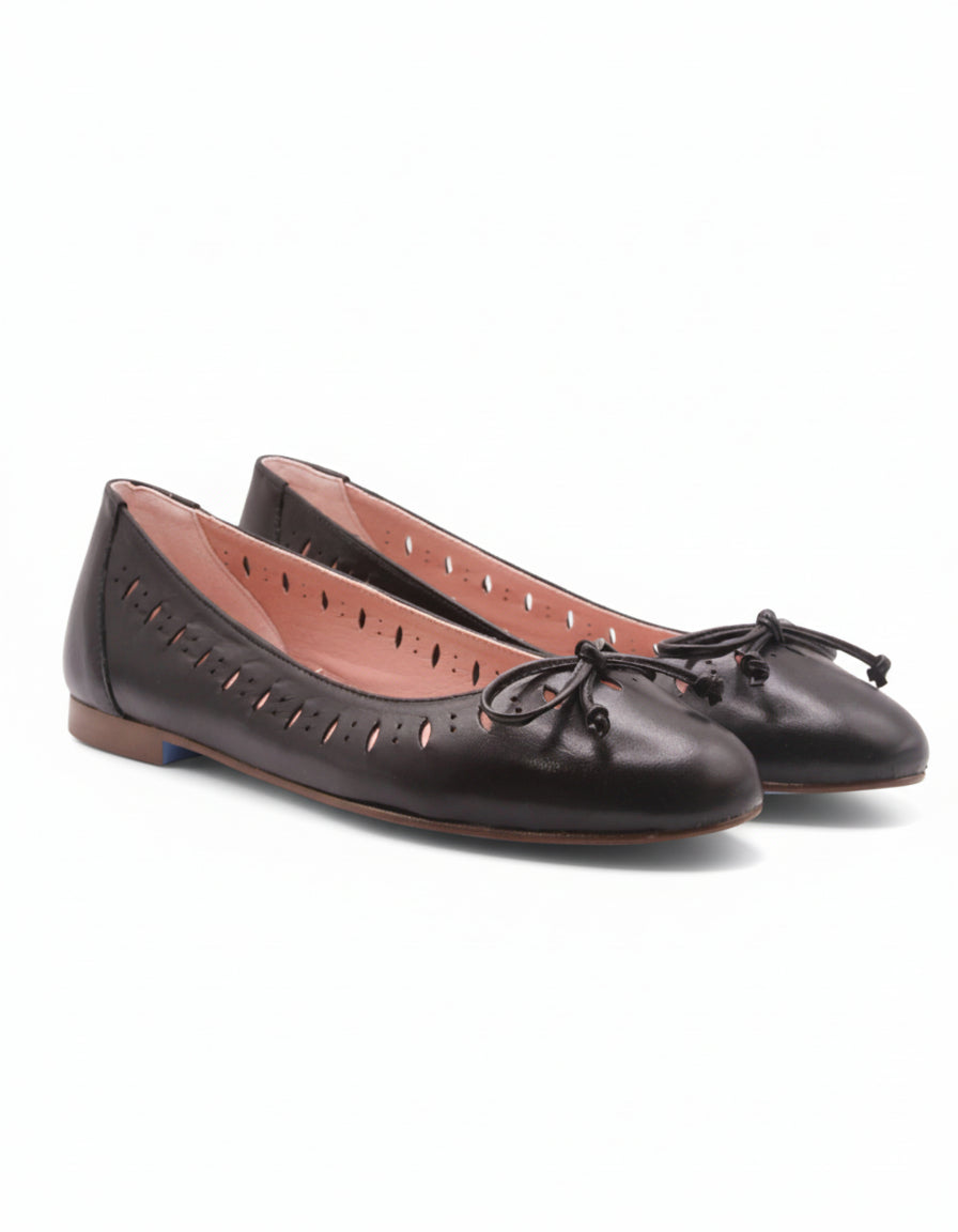 Black leather ballet flats with decorative bow on a white background