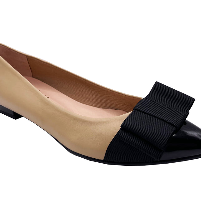 beige leather ballet flat with a pointed patent toe and a layered ribbon bow on the front. angle view