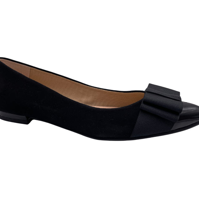 Black suede ballet flat with a pointed patent toe and a layered ribbon bow on the front. angle view 