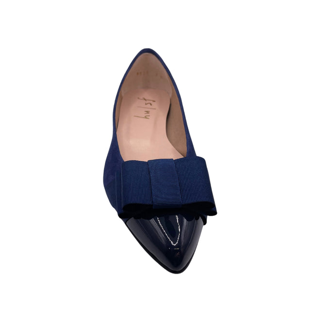 navy suede ballet flat with a pointed patent toe and a layered ribbon bow on the front. front view 