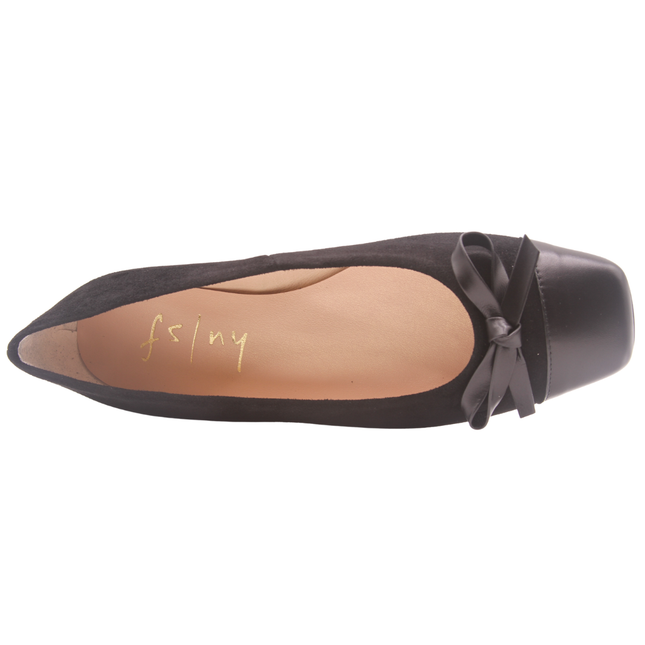 black suede ballet flat with a low heel, leather cap toe, and a small matching leather bow on the front square tow top view