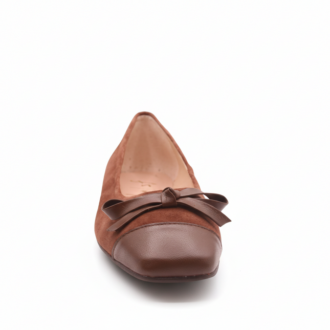 Brown suede ballet flat with a low heel, leather cap toe, and a small matching leather bow on the front square tow front view