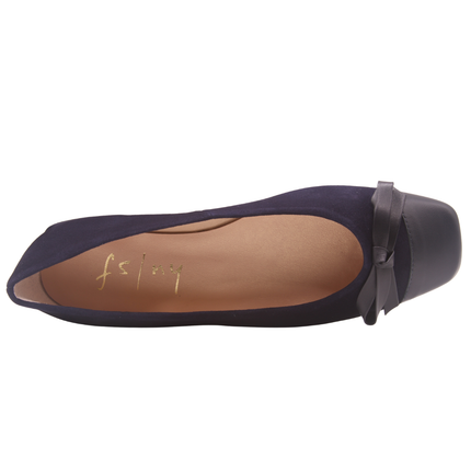 Navy suede ballet flat with a low heel, leather cap toe, and a small matching leather bow on the front square tow top view