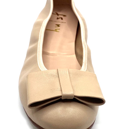 Beige leather ballet flat with a rounded toe and a large folded bow accent on the front. front  view 