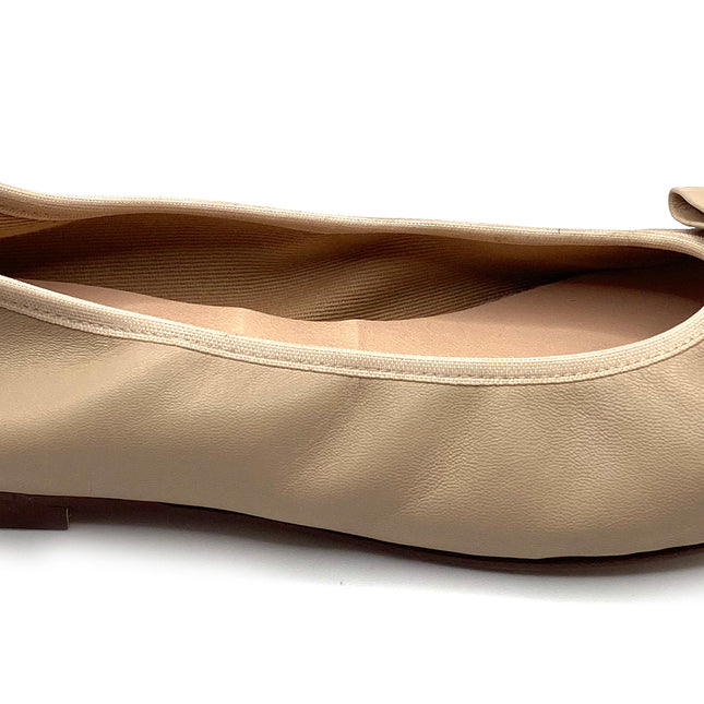 Beige leather ballet flat with a rounded toe and a large folded bow accent on the front. Side view