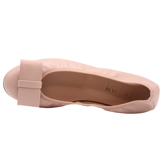 Blush leather ballet flat with a rounded toe and a large folded bow accent on the front. top view 