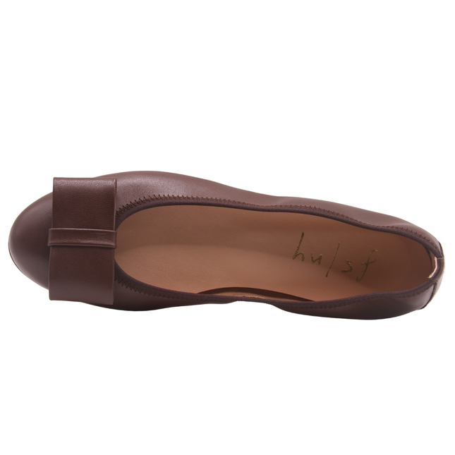 chocolate brown leather ballet flat with a rounded toe and a large folded bow accent on the front. top view 