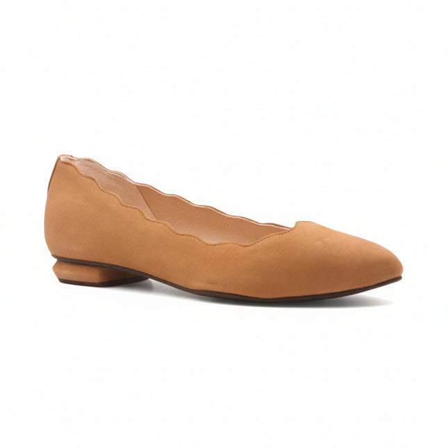 Tan suede flat shoe on a white background