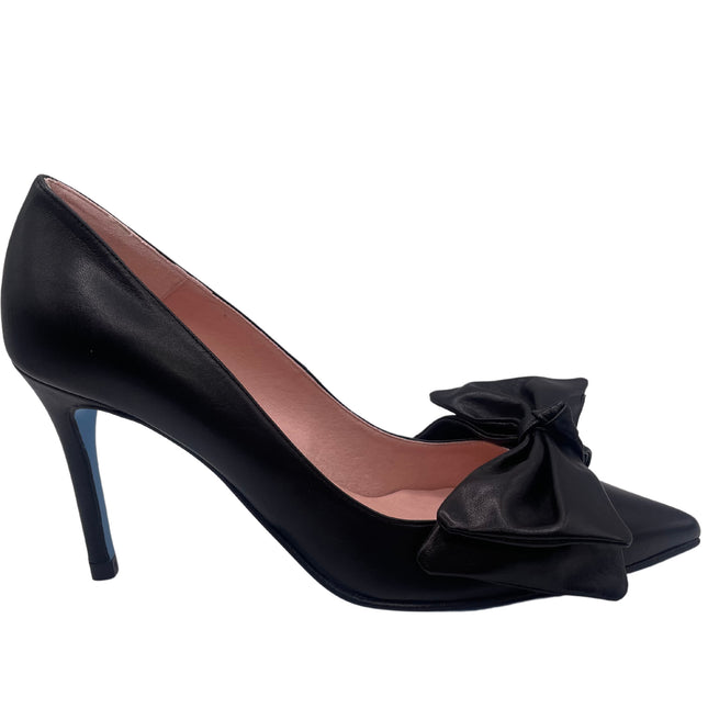A black leather heel with a pointed toe and an oversized bow on the top.