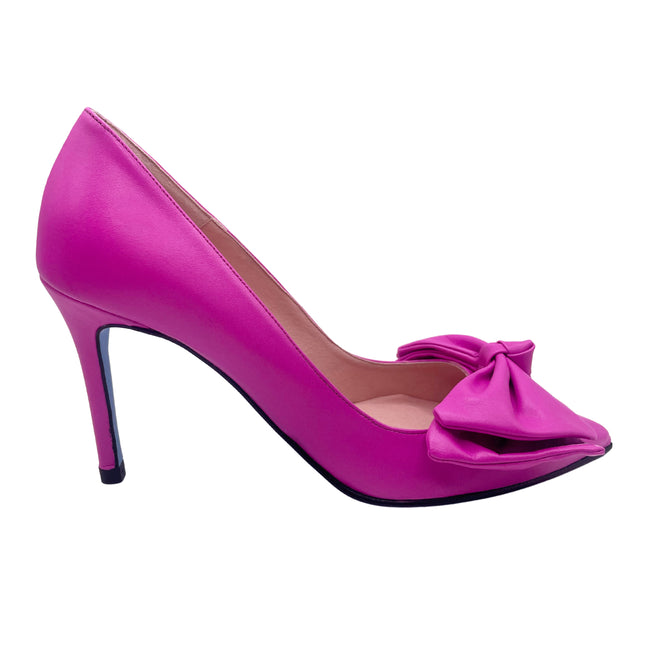 A bright pink leather high heel with an oversized bow, displayed against a white background.