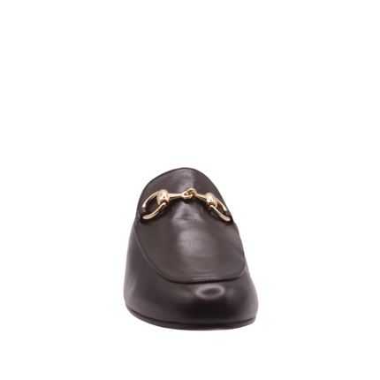 Black leather mule with almond toe, low heel, and a gold buckle detail on the upper front view 