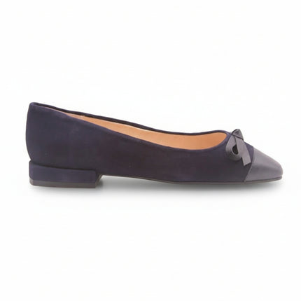 Navy suede ballet flat with a low heel, leather cap toe, and a small matching leather bow on the front square tow Side view
