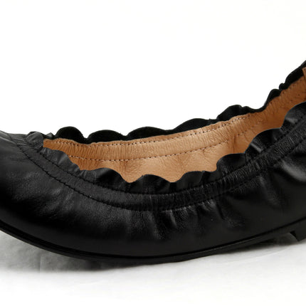 black leather ballet flat with a rounded toe and elasticated topline. angle view