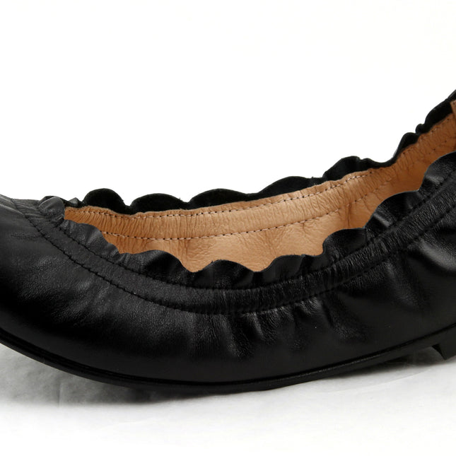 black leather ballet flat with a rounded toe and elasticated topline. angle view