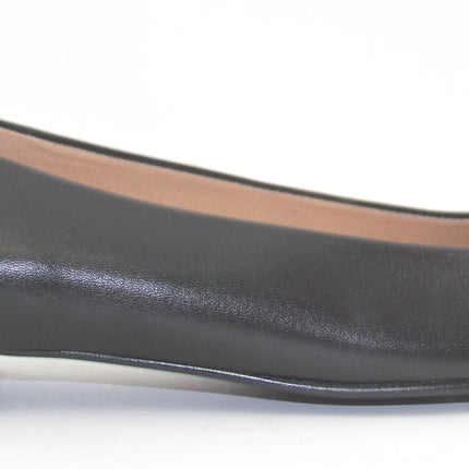 Black leather flat with a square toe, a small heel for slight lift, and a textured black buckle with silver detailing on the toe box side view 