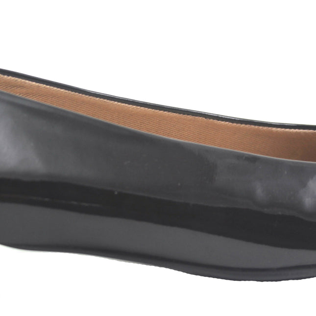 Black patent flat with a square toe, a small heel for slight lift, and a textured black buckle with silver detailing on the toe box