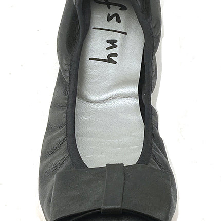 black metallic leather ballet flat with a rounded toe and a large folded bow accent on the front. top view 