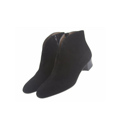 Black suede ankle boot with a low block heel and a smooth, minimal silhouette. both shoes on an angle 