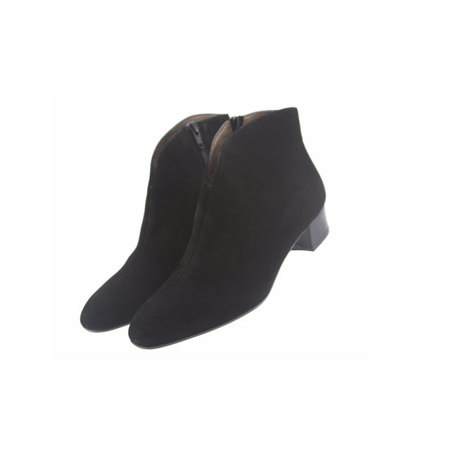 Black suede ankle boot with a low block heel and a smooth, minimal silhouette. both shoes on an angle 