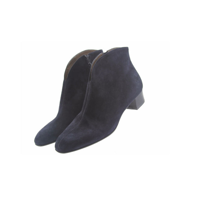 Navy suede ankle boot with a low block heel and a smooth, minimal silhouette. Angle view both shoes 